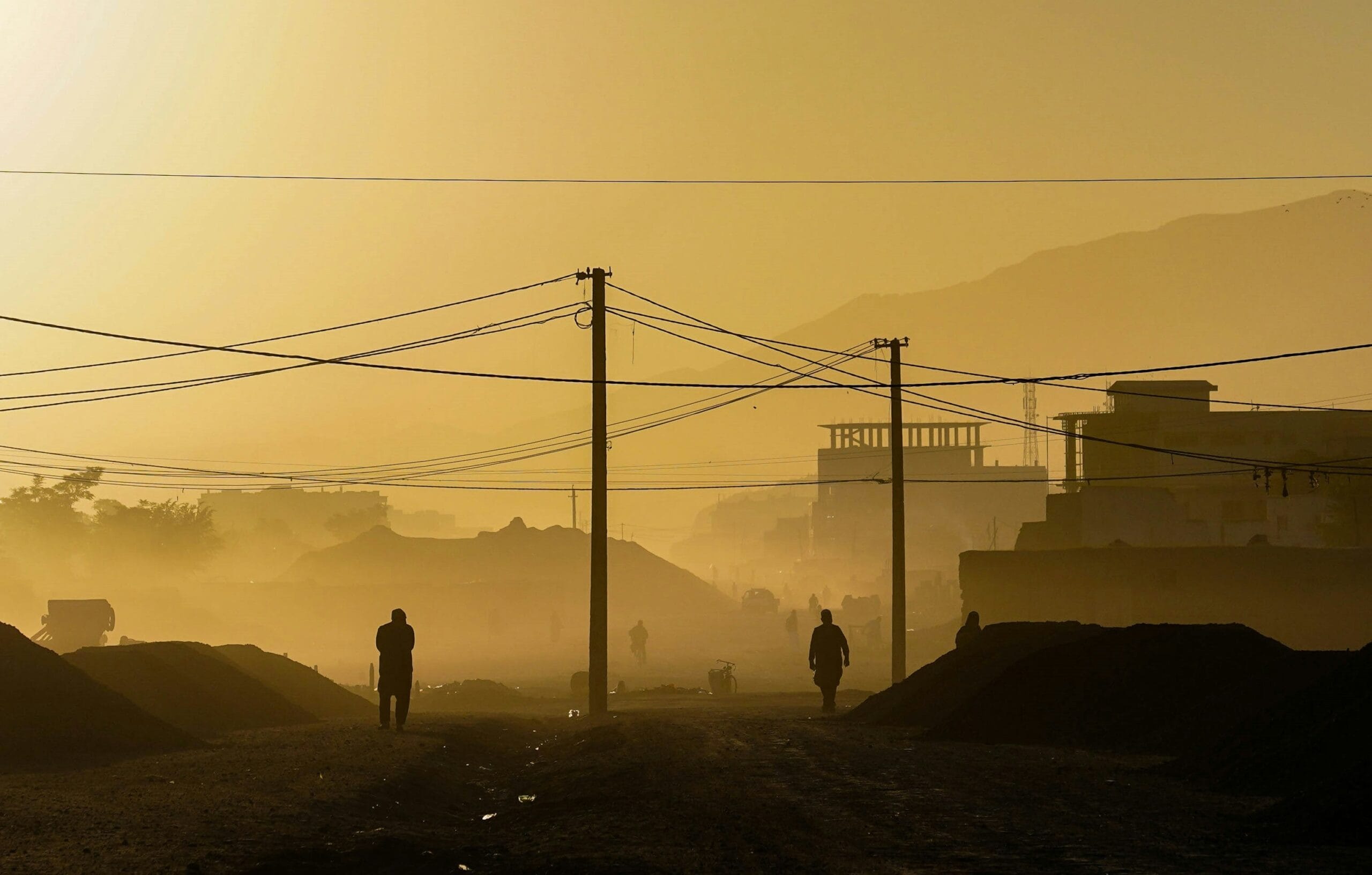 Silhouette of person standing on hill during daytime